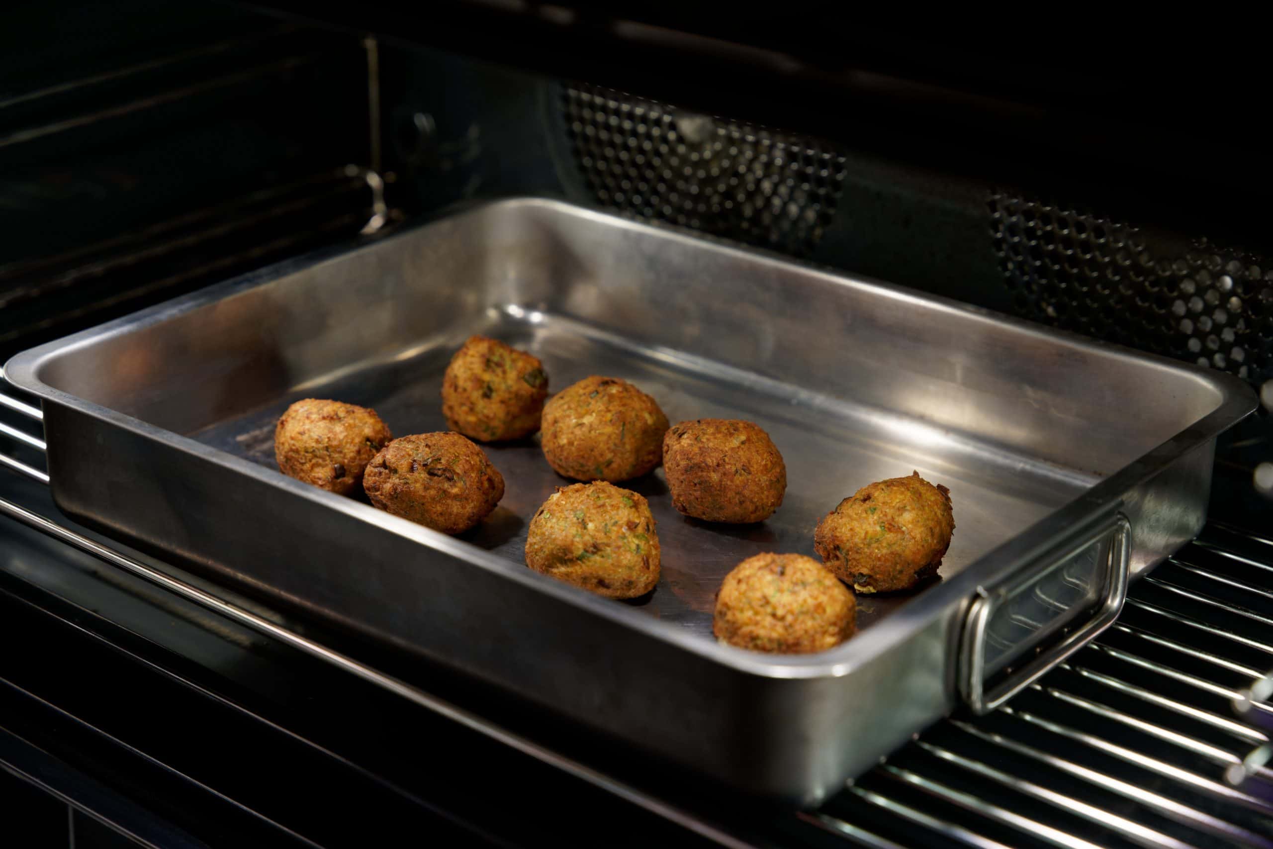 Traditional Greek Kolokithokeftedes (Fried Zucchini/Courgette Balls) baked