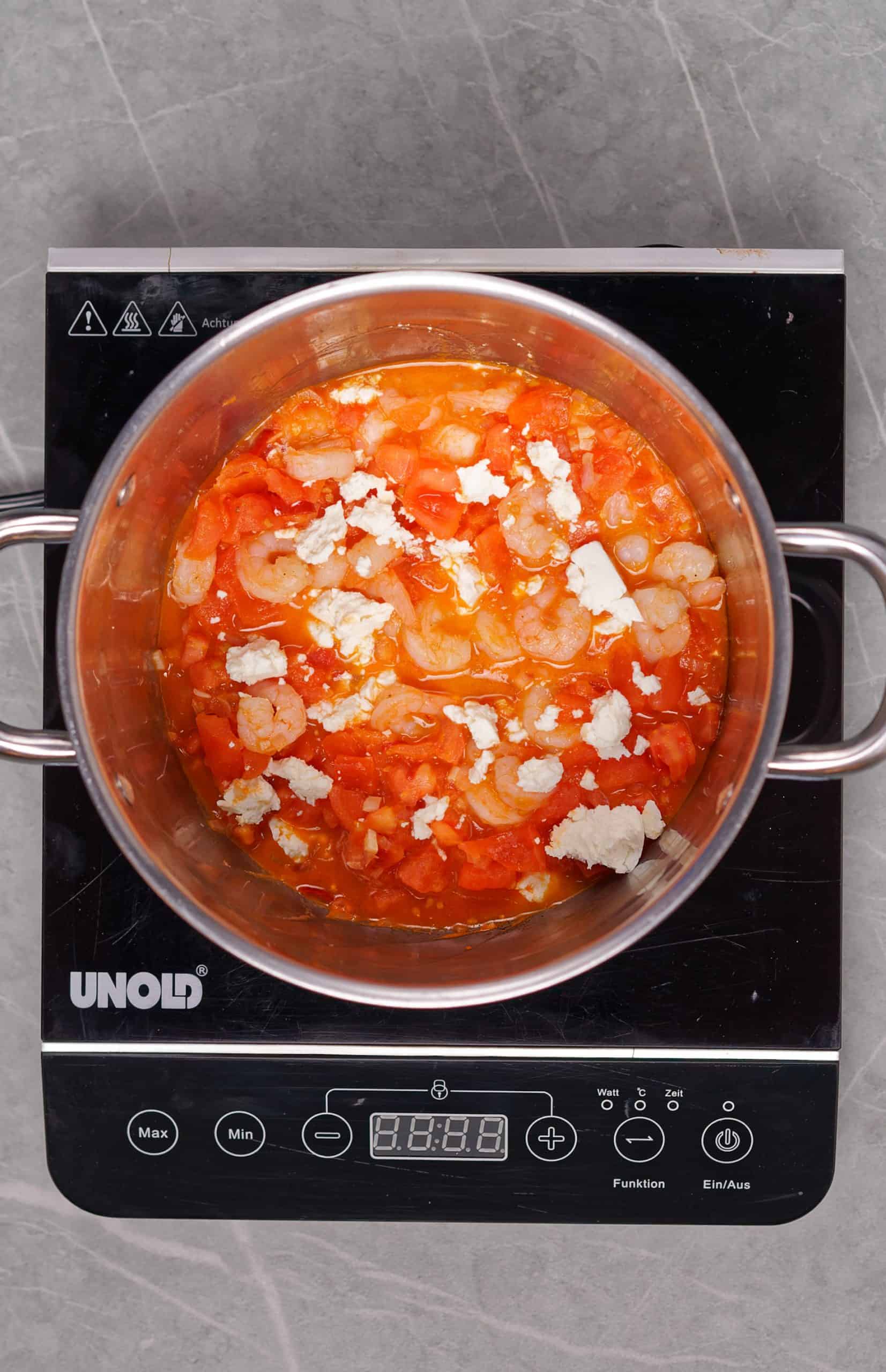 Greek Shrimp Saganaki recipe with Feta cheese (Garides Saganaki) - mixing the shrimp and sauce together