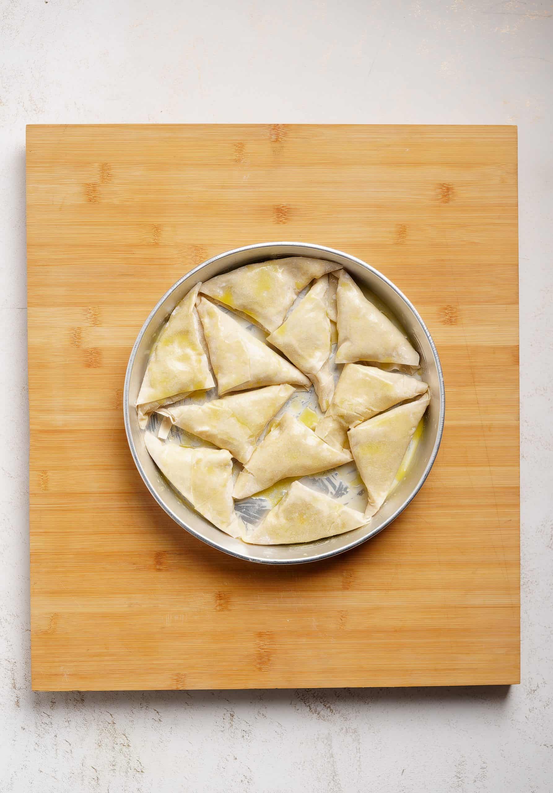 Mini Spanakopita Triangles Recipe (Spanakopitakia - Greek spinach triangles) in the baking tray