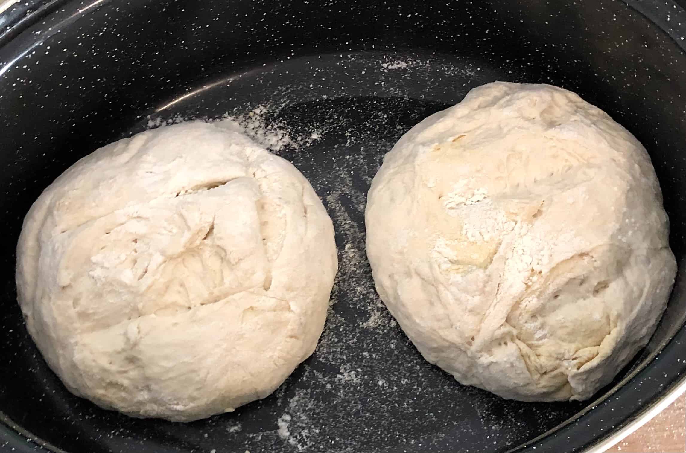 No knead bread dough scored and in the dutch oven